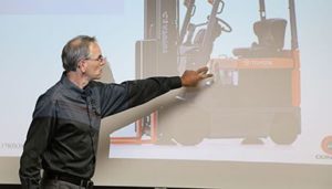A forklift trainer teaching a class with a slideshow presentation
