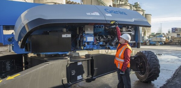 A boom lift operator performing a pre-start inspection