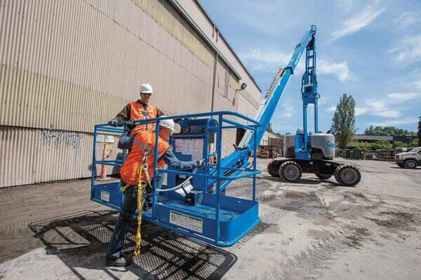 Two boom lift operators in the basket