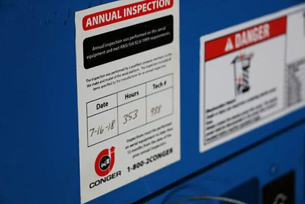 An annual inspection sticker on the side of a scissor lift