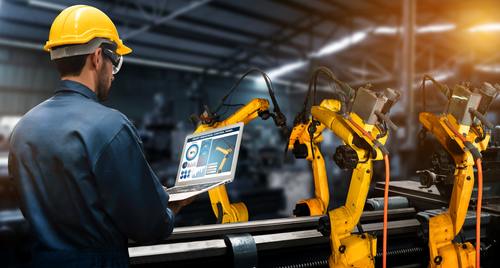 automation-min_500x Worker monitors robotic arms