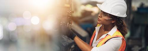 Female worker operating a machine