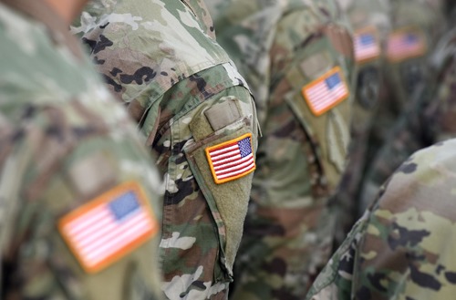 Veterans in uniform with American flag patches