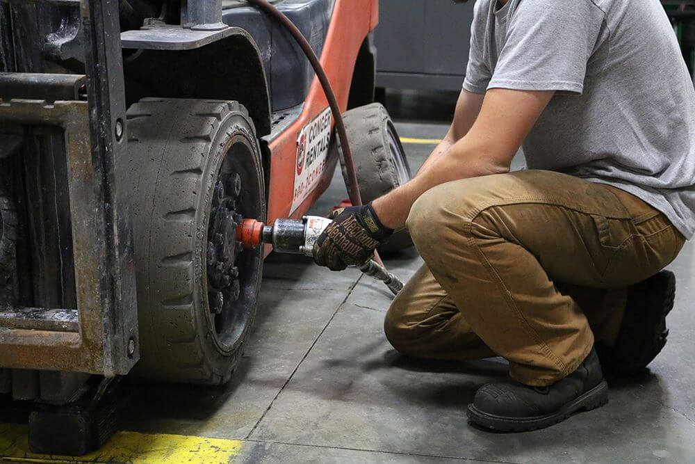 technician removes cushion tires