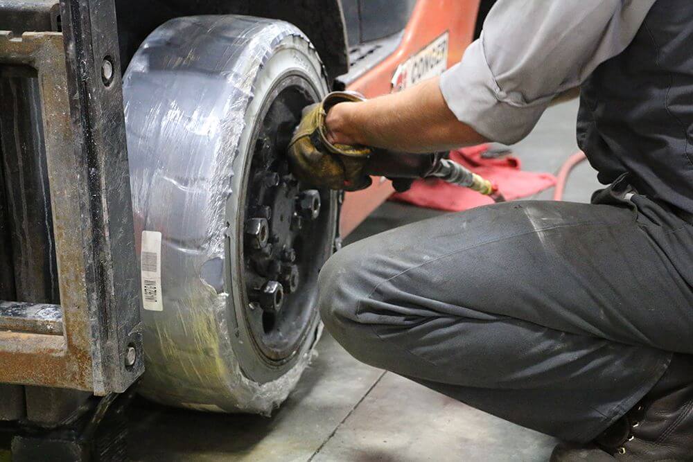 technician replaces cushion tire