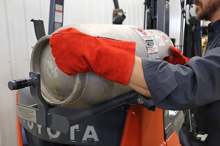 operator removes empty propane tank