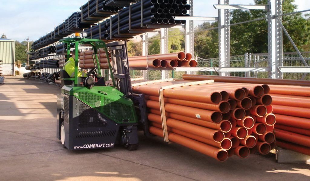 Combilift mult-directional forklift carrying a load of pipes