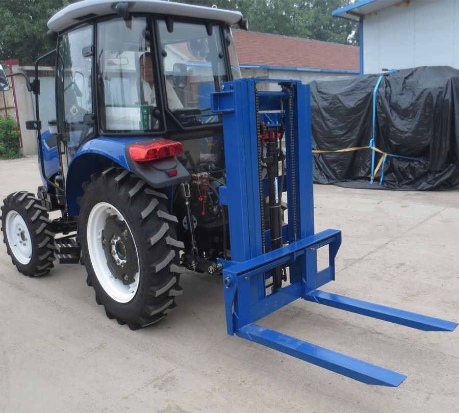 Forklift mast mounted on back of tractor