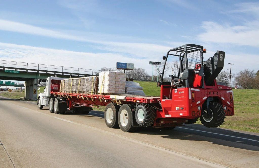 Trailer-mounted forklift on highway