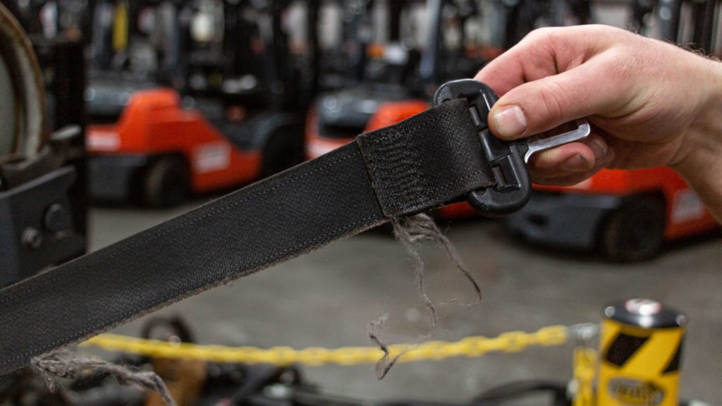 A frayed forklift seat belt