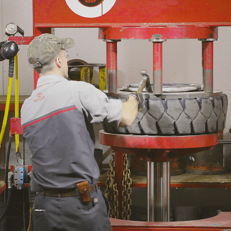 Using a forklift tire press