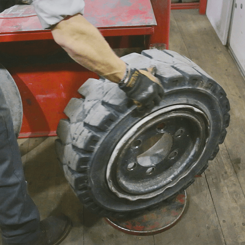 Forklift tire about to be pressed