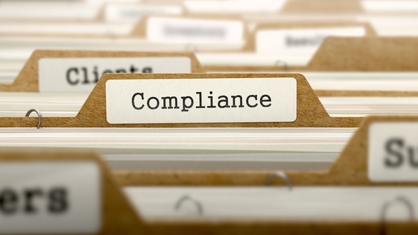 A file folder labeled "Compliance"