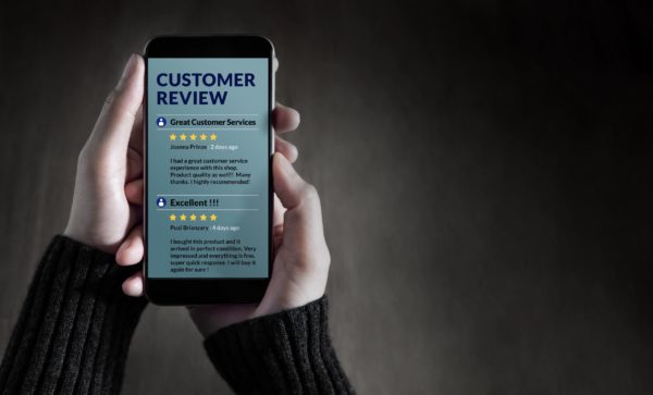 A person reading customer reviews on a smartphone