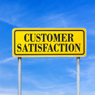 A road sign reading "Customer Satisfaction"