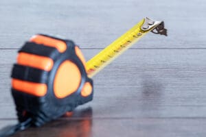 Tape measure on a wooden dark table