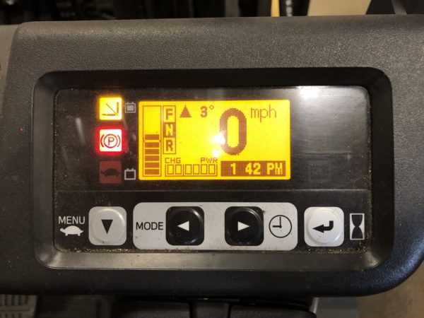 The instrument panel on an electric sit-down rider forklift