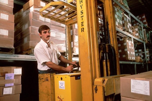 reach-truck-forklift-aisle A worker operating a Hyster narrow aisle reach truck forklift