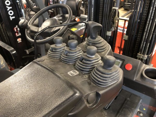 Finger control-style hydraulic levers on an electric sit-down rider forklift