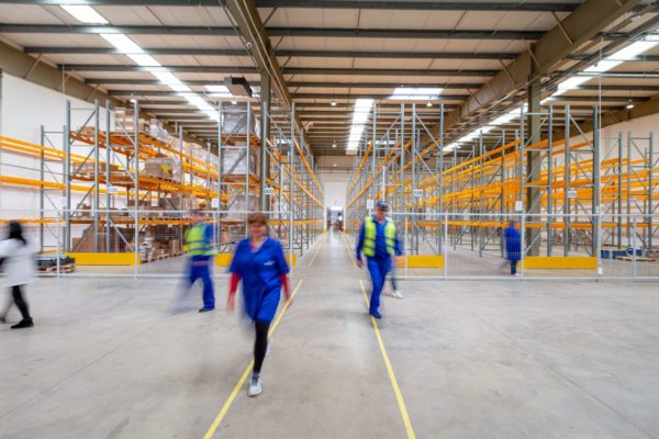 warehouse-worker-cross-traffic Several warehouse workers walking in different directions