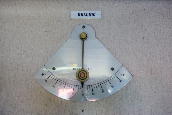 An analog clinometer attached to concrete