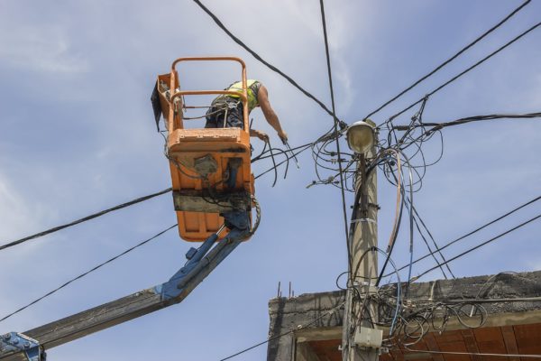 A boom lift operator sawing through a power line