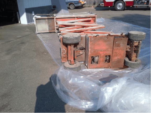 A scissor lift that's tipped over onto it's side