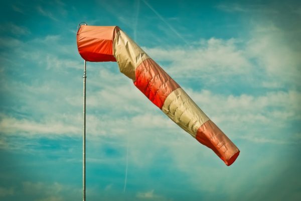 A wind sock hanging on a pole indicating the wind direction