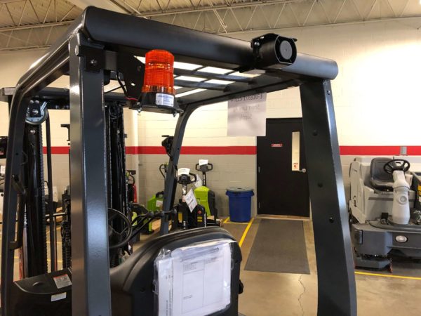 An orange strobe light installed on a Toyota internal combustion forklift