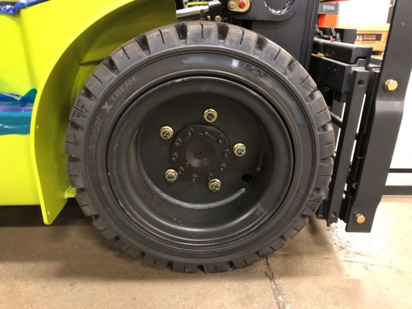 A solid pneumatic drive tire on a CLARK forklift