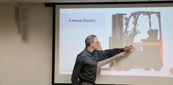 A forklift operator trainer teaching a class