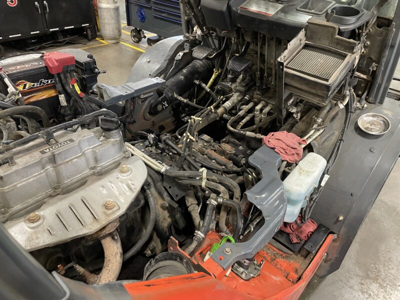 toyota forklift with floorboards off being repaired