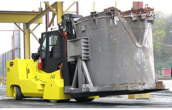 A Hoist high-capacity forklift carrying a foundry cauldron