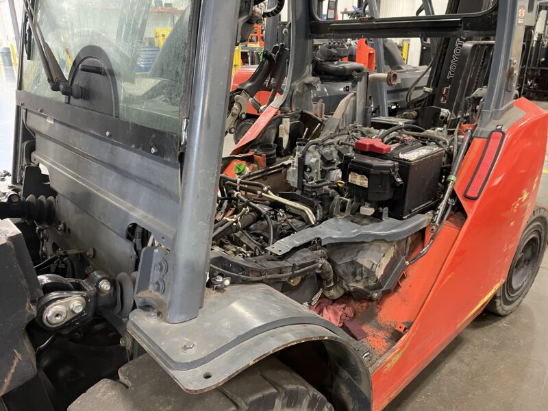 toyota lift truck with floor boards removed being serviced
