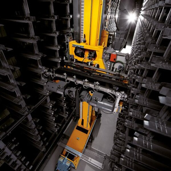 A mini-load ASRS crane retrieving inventory from pallet racking