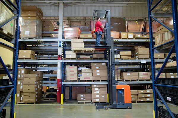 An operator on a lifted Toyota order picker