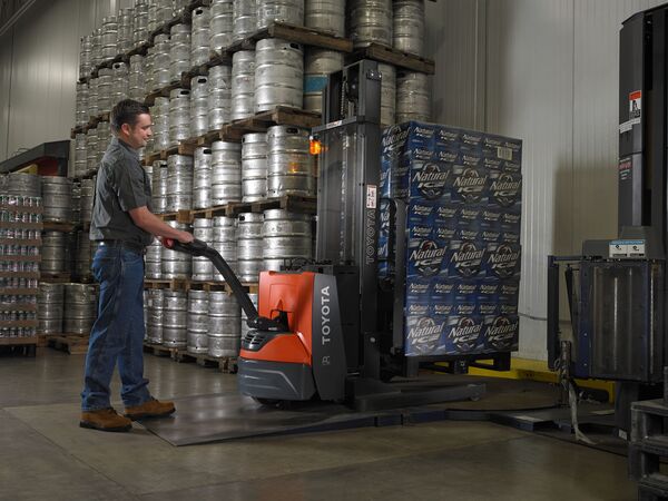 A Toyot walkie stacker forklift lifting a pallet