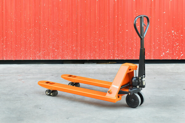 A hand pallet jack with the forks raised