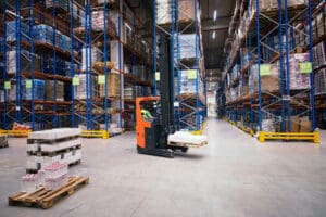 forklift moving pallet in warehouse