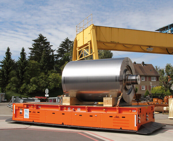 A heavy-hault AGV transporting a large metal cylinder