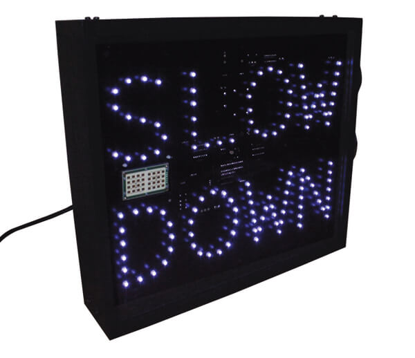 A forklift speed radar sign displaying "Slow Down"