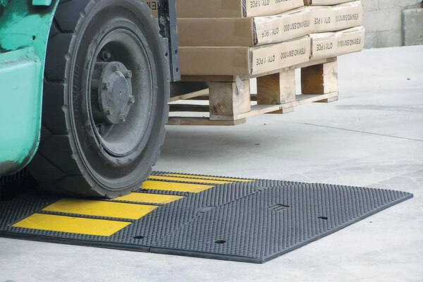 A forklift driving over a speed bump