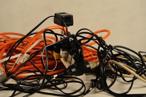 A jumbled pile of electrical extension cords