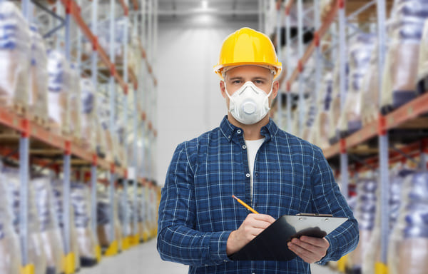 A warehouse worker wearing a hard hat