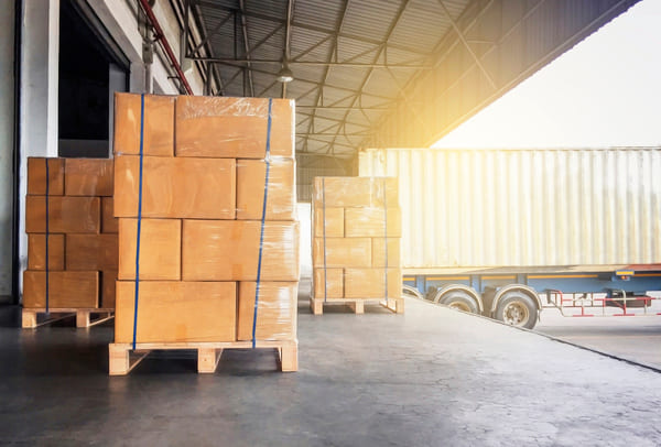 A pallet of boxes stacked in a brick-like manner on a skid