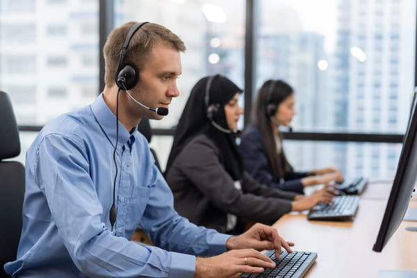 Workers at a call center talking on the phone