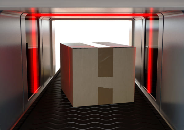 A box moving down a conveyor belt with a laser beam surrounding it