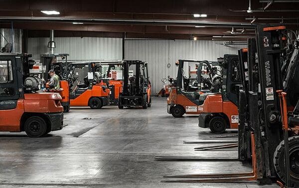 A selection of Toyota forklift trucks parked in a warehouse