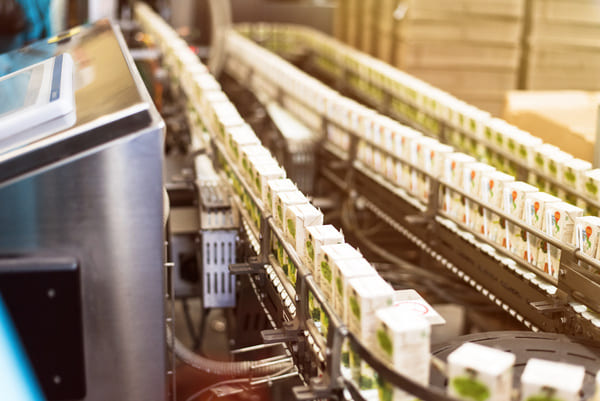 Components moving down a conveyor system in a factory to reduce lead time