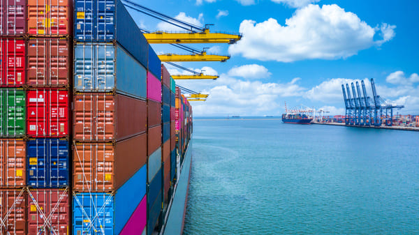 A cargo ship loaded with container sailing into port